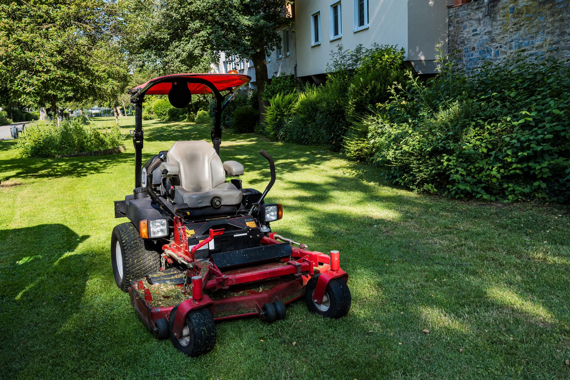 Lawn maintenance with a riding mower in a residential area